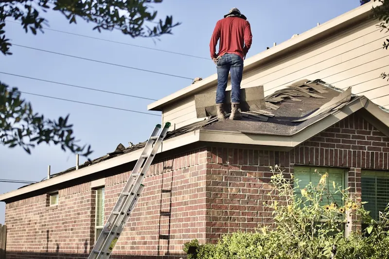Professional roofer working on a residential roof in Saint Hedwig